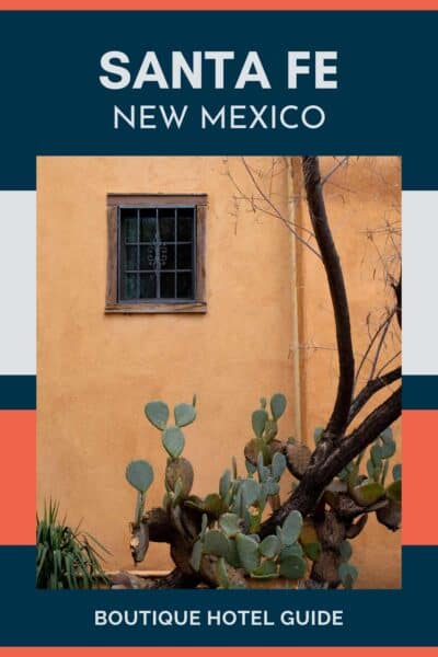 Muted yellow wall with small window and cactus in front.