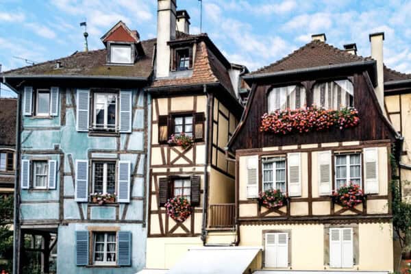 Houses in Colmar with pretty flowers on window sills.