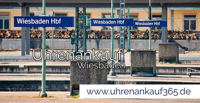 Das Foto zeigt den Wiesbadener Hauptbahnhof sowie den Schriftzug Uhrenankauf Wiesbaden