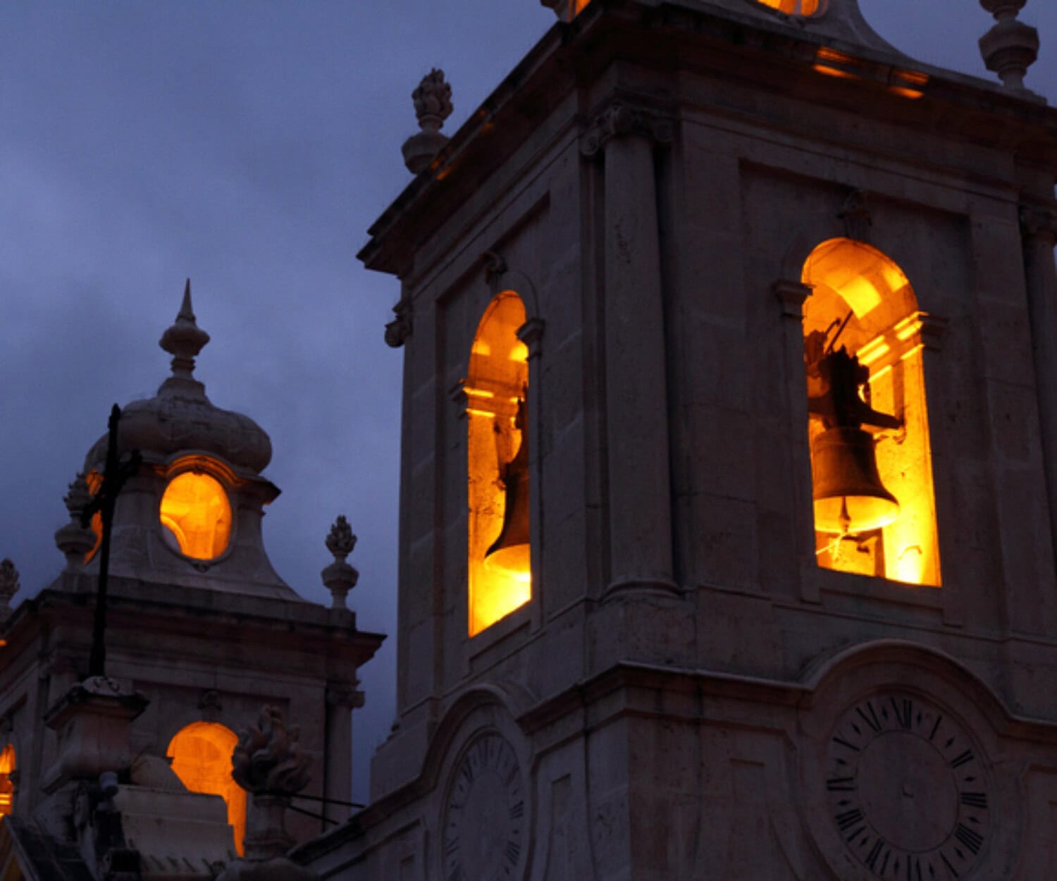 church tower with orange light and bells
