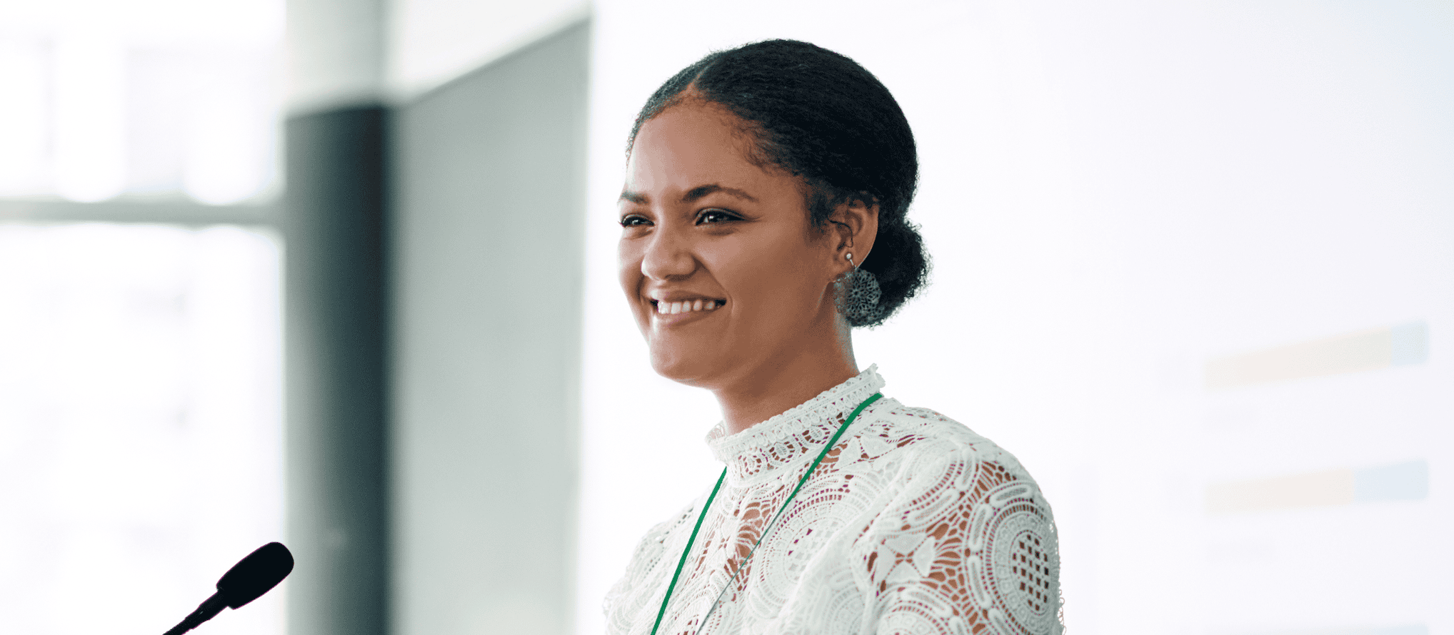 Young confident woman presenting speech at mic