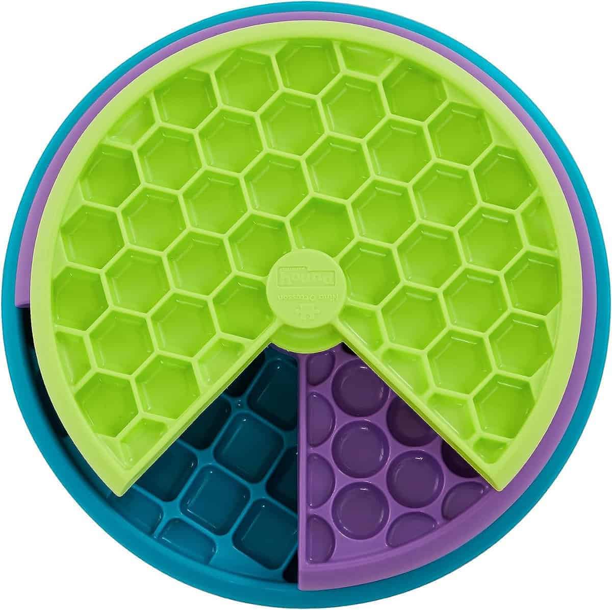 close up of green, purple and blue enrichment slow feeder bowl by outward hound