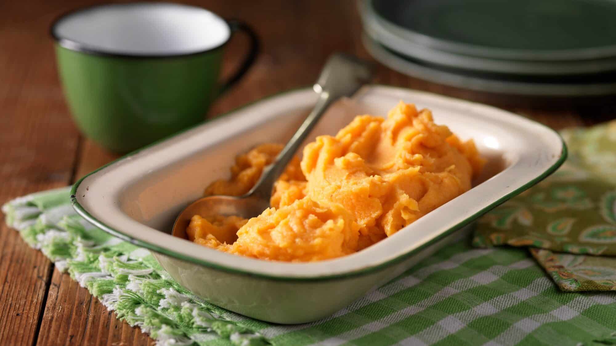 dish of mashed sweet potatoes with spoon, dog-friendly holiday meal