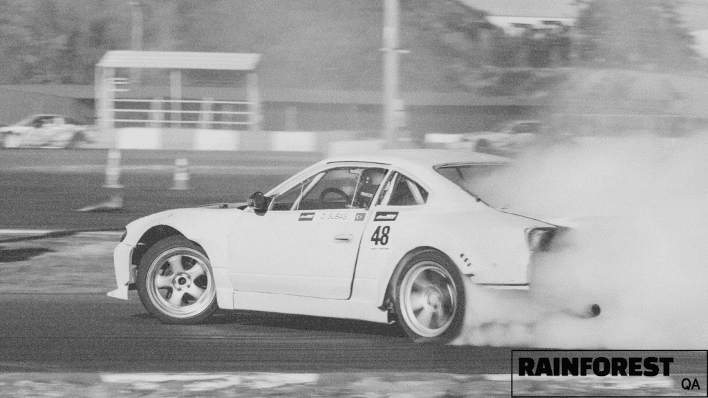 AI-assisted software generation enables building new features at speed. Racecar peeling out shows this metaphorically.