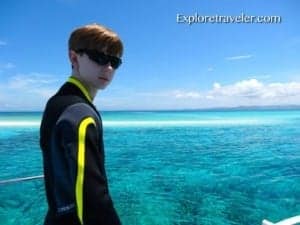 Bakasyon at Scuba Diving sa Coral Reefs ng Pilipinas - A person standing next to a body of water - Leisure