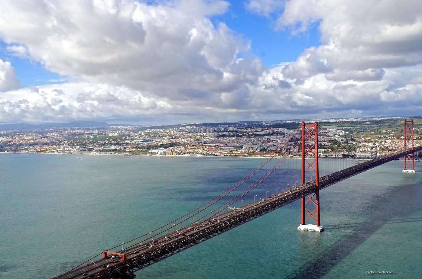 ExploreTraveler Presents: Exploring Lisbon Portugal Part 1 - A bridge over a body of water - Ponte 25 de Abril