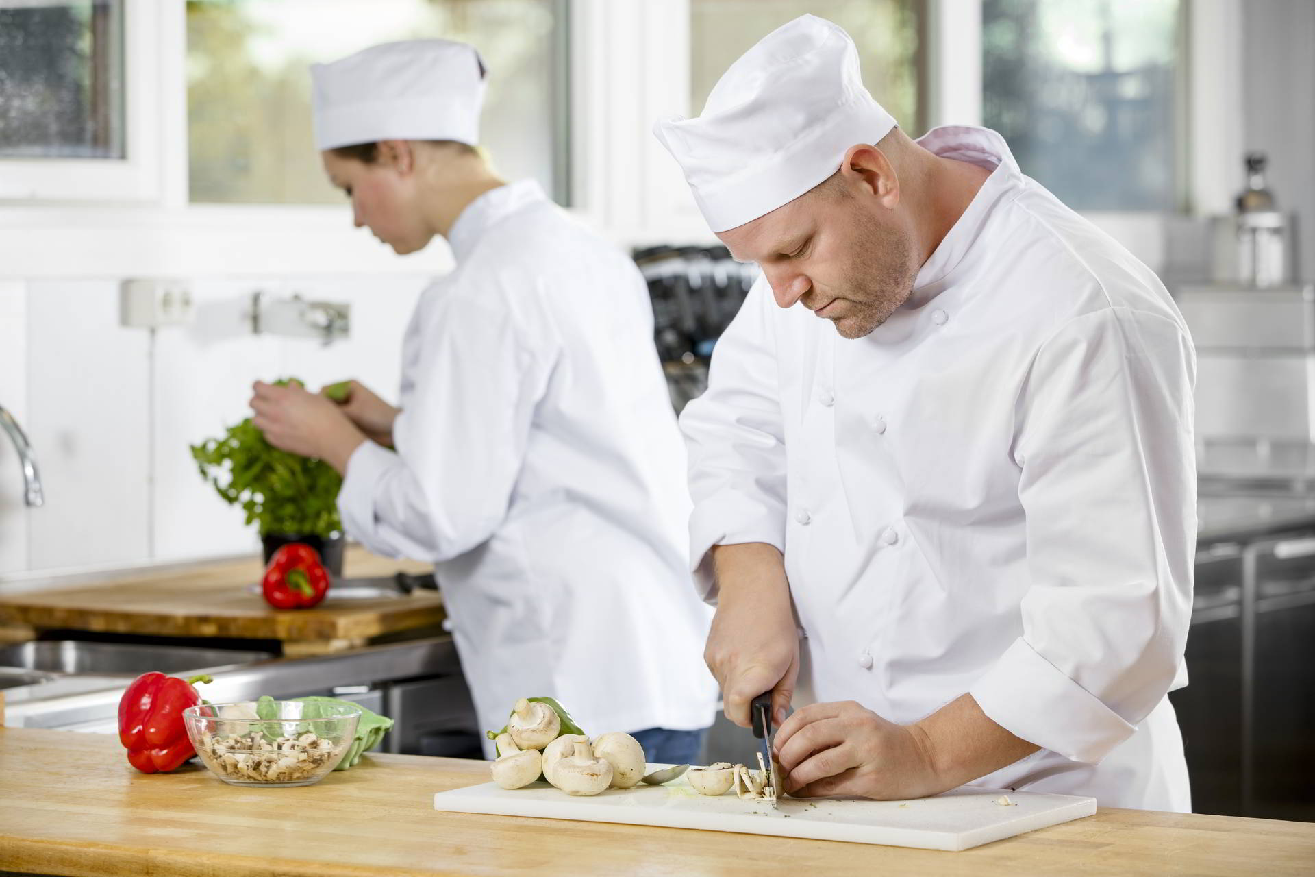professional chefs preparing vegetables large kitchen