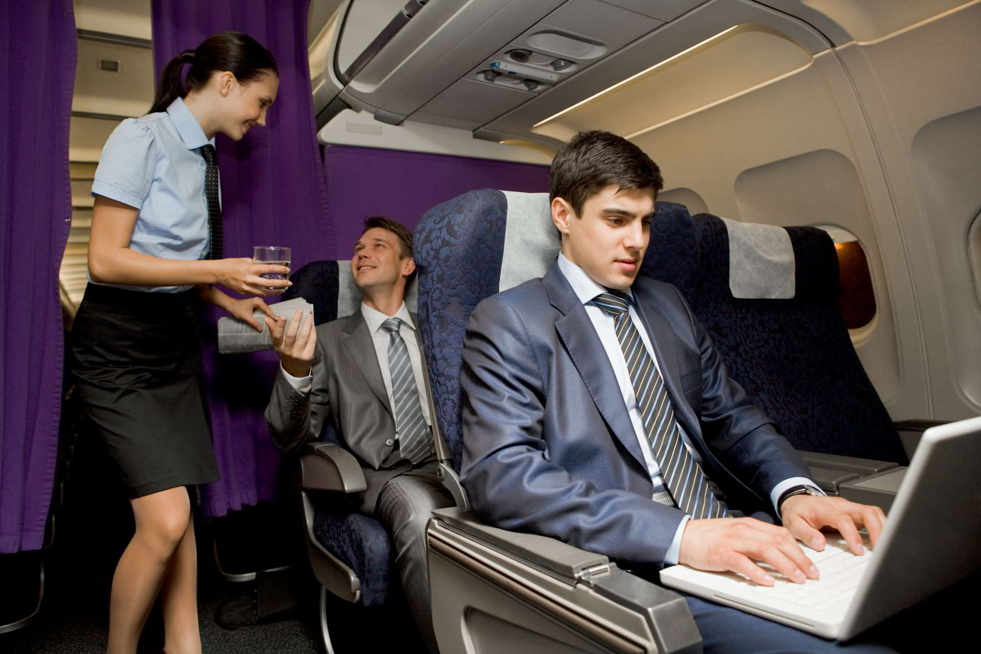 image busy male typing laptop with pretty stewardess giving glass water