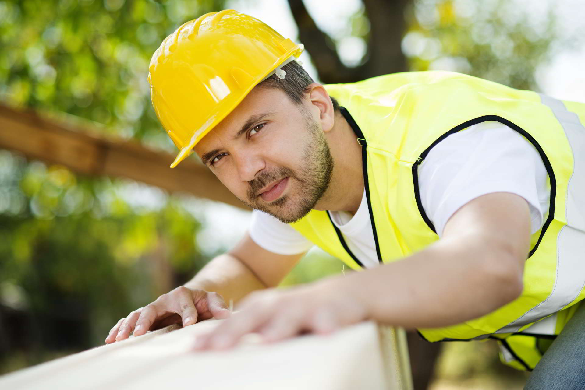 construction worker working with wooden beam