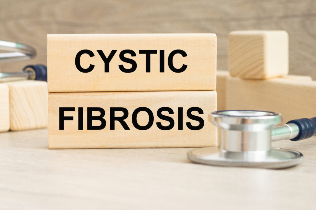 the word CYSTIC FIBROSIS is written on a wooden cubes structure . Can be used for Medical concept.