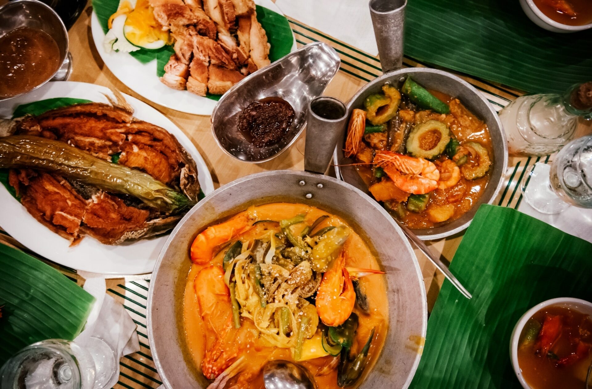 Meal set of various traditional Filippino dishes: Pakbet, lechon kawali, Bale Dutung.