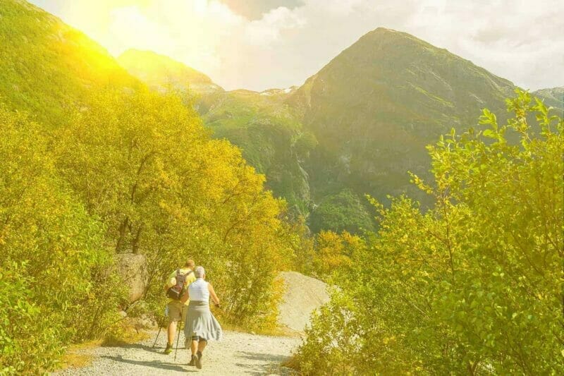 Keeping healthy in retirement - a retired couple walking in the mountains on a bright sunny days