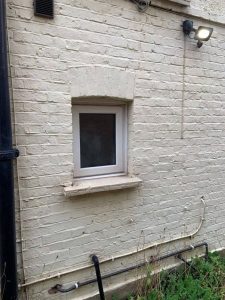 Cracks in brickwork above window