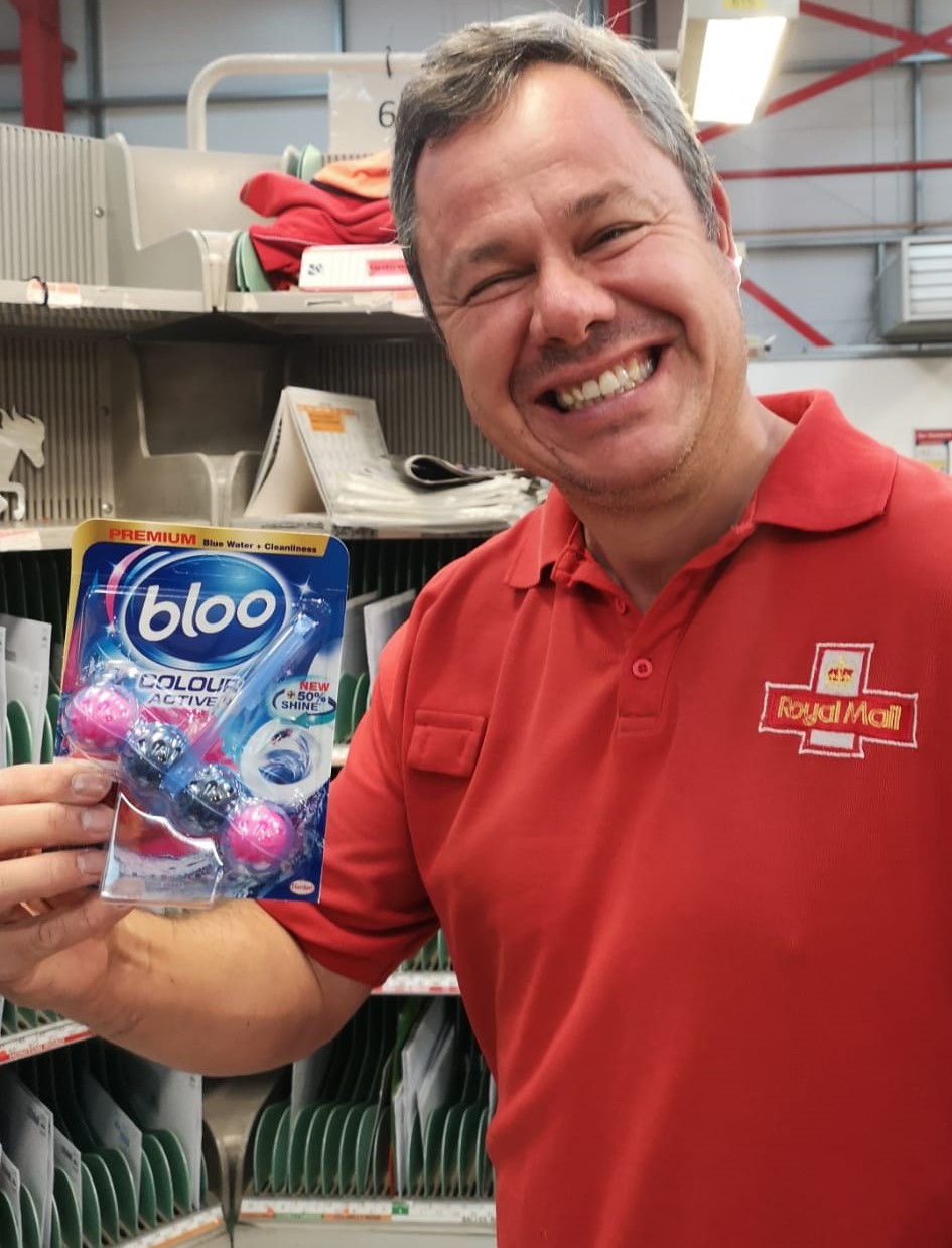 Key Worker Sampling showing a happy Royal Mail worker holding a Bloo Sample